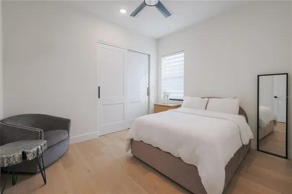 a bedroom with a bed and a chair