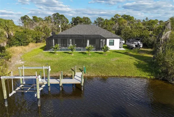 a view of a house with backyard porch and sitting area