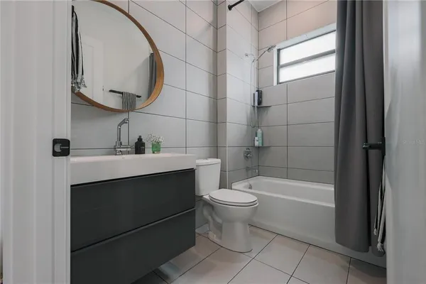 a bathroom with a sink a toilet and bathtub