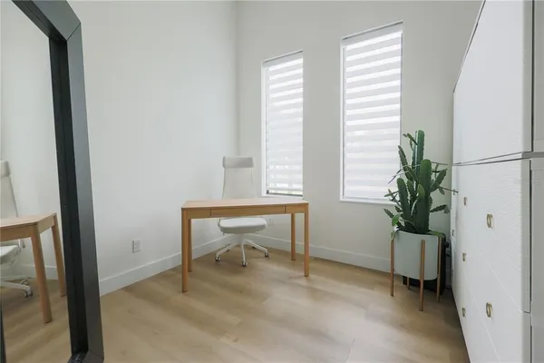 a room that has a window and a potted plant