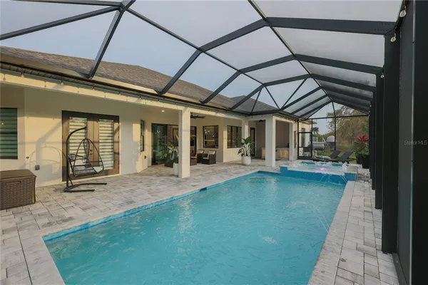 a view of swimming pool with outdoor seating