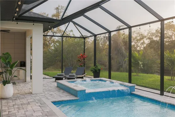 a view of tall trees with a glass door