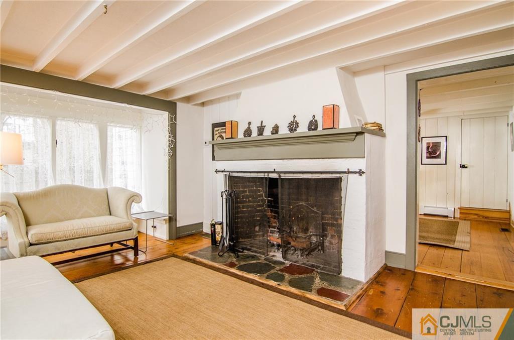 168 Plainsboro Road Cranbury, NJ 08512 - Photo 12 of 25 a living room with furniture and a fireplace
