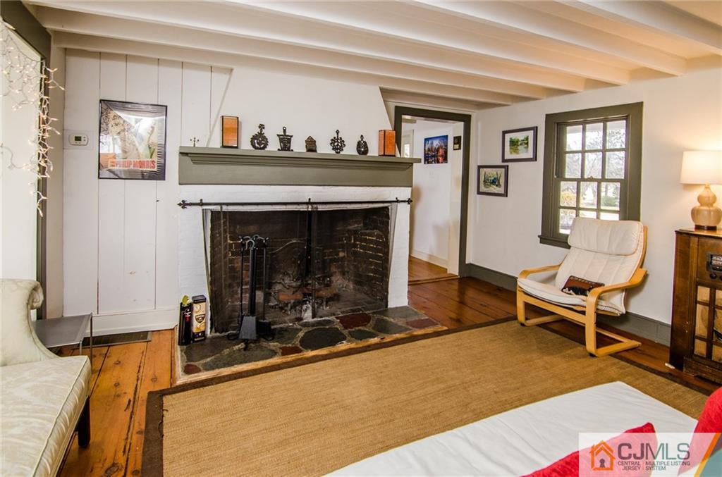 168 Plainsboro Road Cranbury, NJ 08512 - Photo 13 of 25 a living room with furniture a fireplace and a window