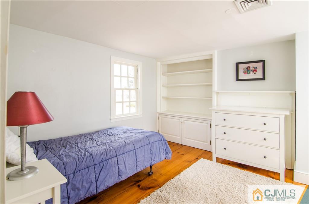 168 Plainsboro Road Cranbury, NJ 08512 - Photo 19 of 25 a bedroom with a bed and a lamp on dresser