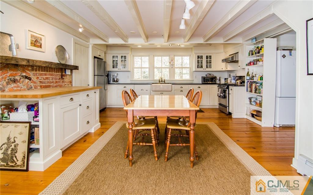 168 Plainsboro Road Cranbury, NJ 08512 - Photo 5 of 25 a dining room with furniture and a kitchen view