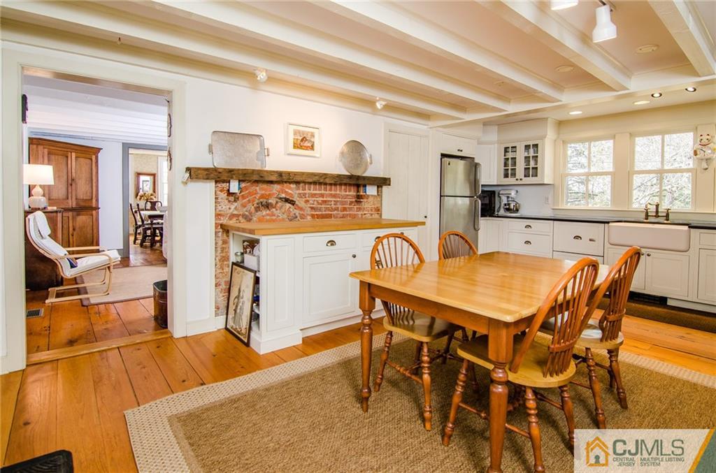 168 Plainsboro Road Cranbury, NJ 08512 - Photo 6 of 25 a dining hall with stainless steel appliances kitchen island granite countertop furniture and wooden floor