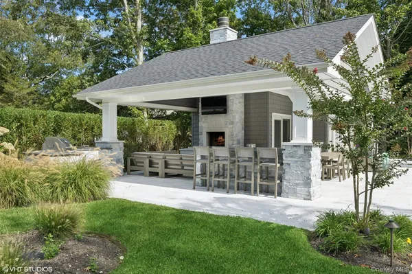 a front view of house with yard and outdoor seating
