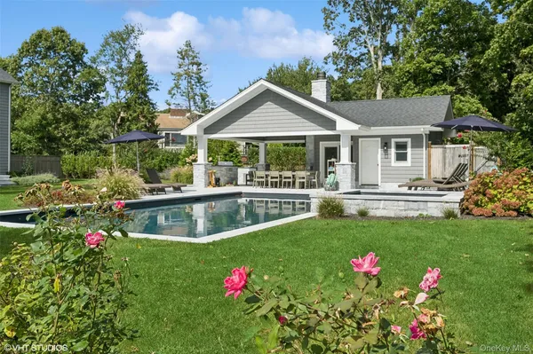 a front view of house with yard and trees around