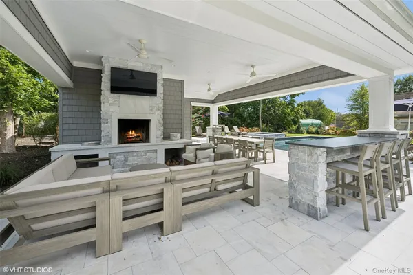 a living room with furniture a fireplace and a floor to ceiling window