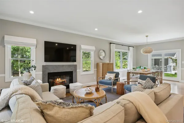 a living room with furniture fireplace and window