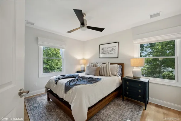 a bedroom with a bed and a large window
