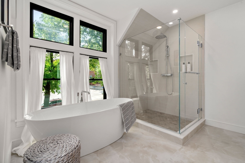 11 Ashford Road Newton, MA 02459 - Photo 18 of 41 a bathroom with a glass shower door and a window