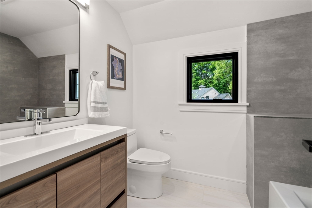 11 Ashford Road Newton, MA 02459 - Photo 22 of 41 a bathroom with a sink a toilet and a mirror
