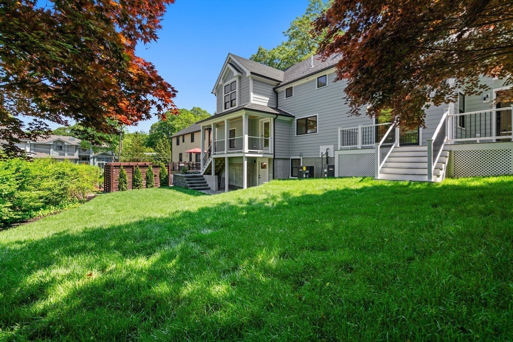 11 Ashford Road Newton, MA 02459 - Photo 35 of 41 a front view of a house with a yard table and chairs