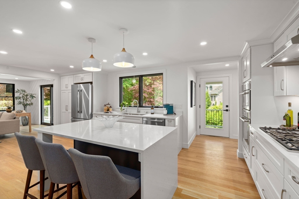 11 Ashford Road Newton, MA 02459 - Photo 4 of 41 a large kitchen with kitchen island a large counter top space a sink stainless steel appliances and cabinets