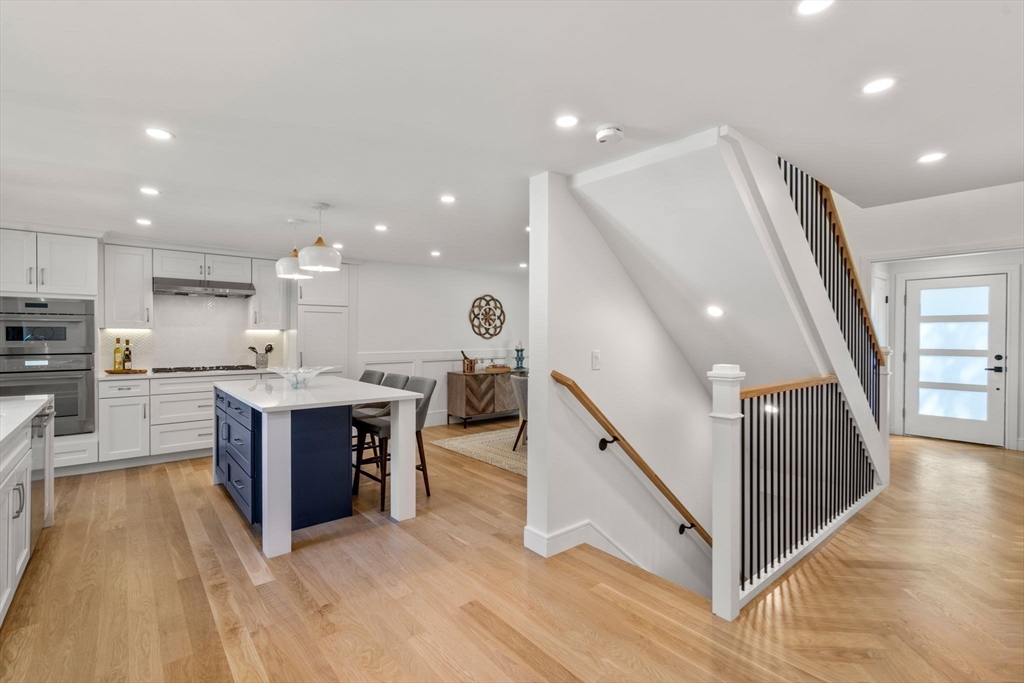 11 Ashford Road Newton, MA 02459 - Photo 8 of 41 a open kitchen with wooden floor and stainless steel appliances