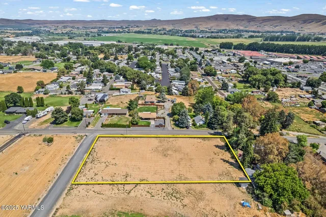 an aerial view of residential houses with outdoor space and river
