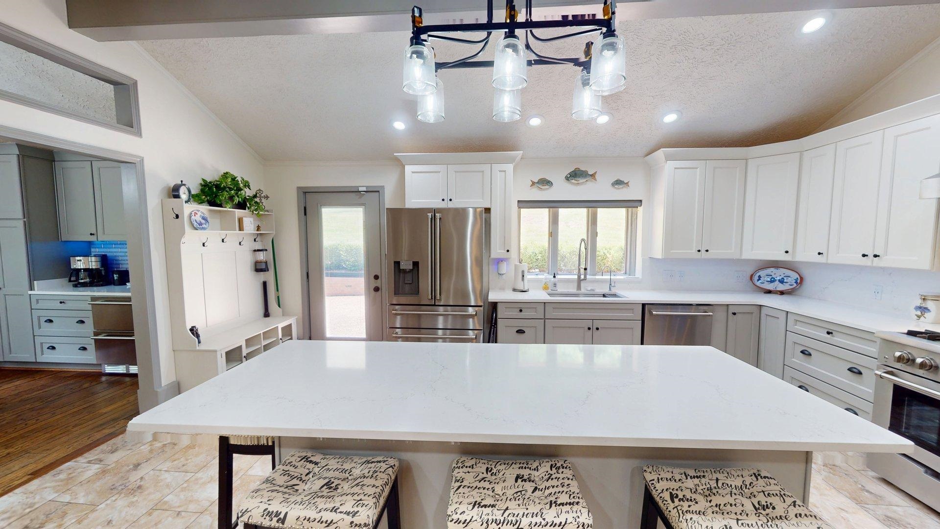 650 Caney Hollow Road Counce, TN 38326 - Photo 6 of 40 a large kitchen with kitchen island a stove a refrigerator a sink dishwasher and wooden cabinets with wooden floor
