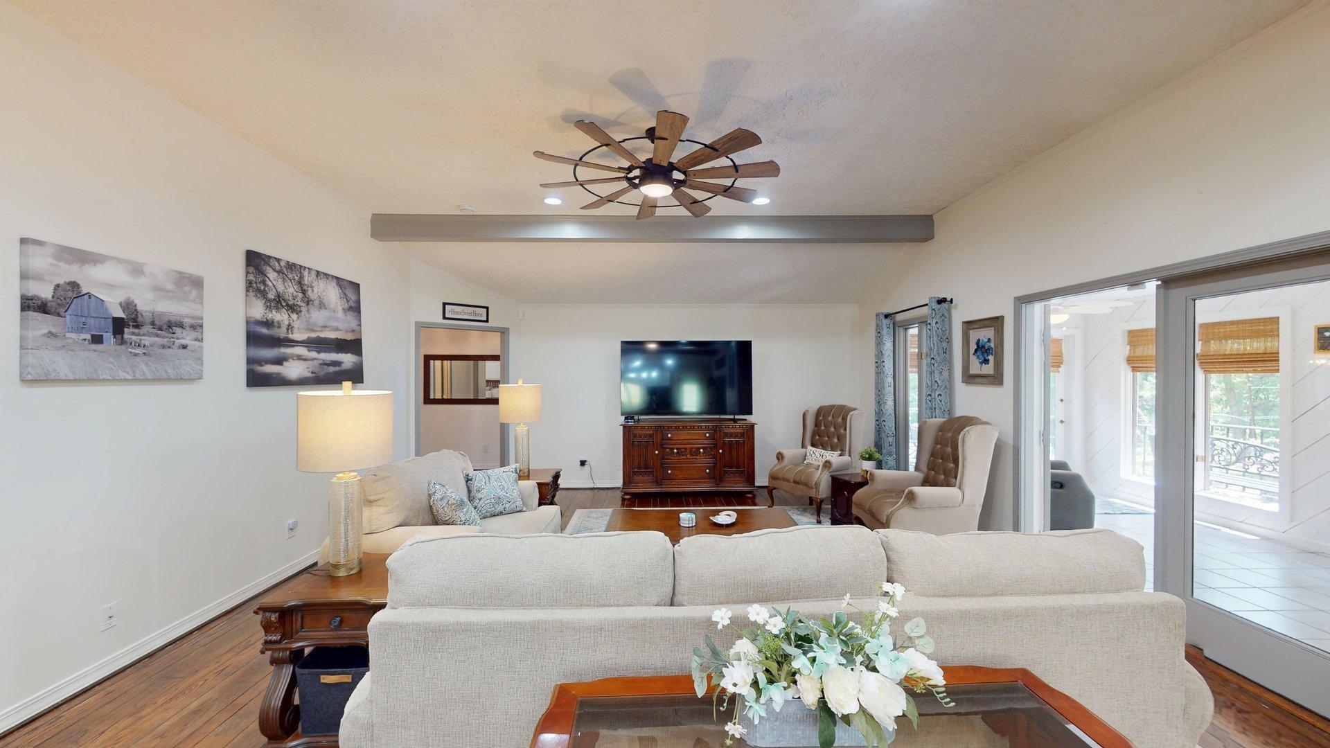 650 Caney Hollow Road Counce, TN 38326 - Photo 10 of 40 a living room with furniture chandelier and a flat screen tv