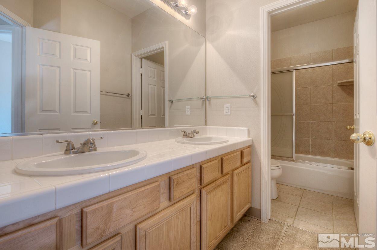 1580 Sutterbrook Way Reno, NV 89521 - Photo 19 of 25 a bathroom with a double vanity sink and a mirror