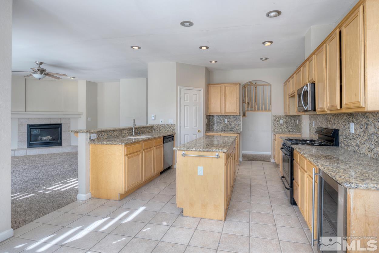 1580 Sutterbrook Way Reno, NV 89521 - Photo 6 of 25 a kitchen with a sink a stove top oven and cabinets