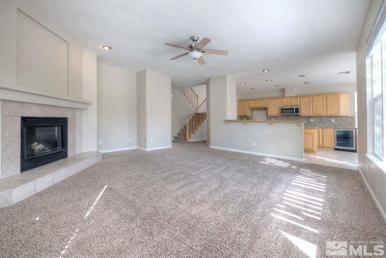 1580 Sutterbrook Way Reno, NV 89521 - Photo 10 of 25 a view of a kitchen and a fireplace a ceiling fan in a kitchen
