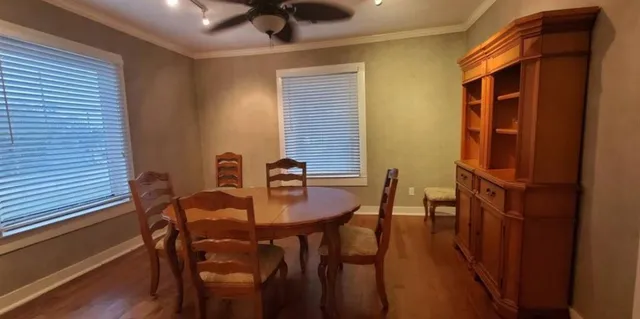 a view of a dining room with furniture and wooden floor