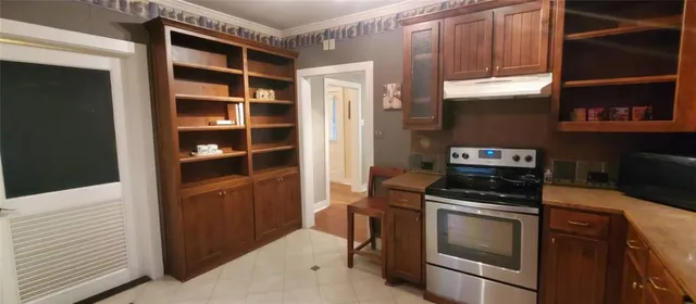a kitchen with cabinets and appliances