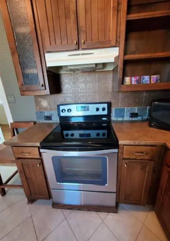 a stove top oven sitting inside of a kitchen