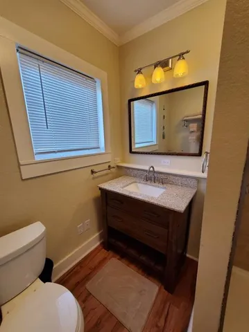 a bathroom with a toilet sink and mirror