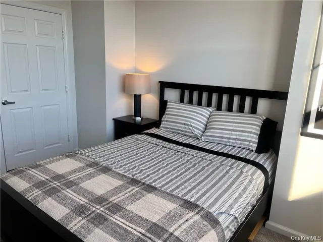 a bedroom with a bed and a night stand