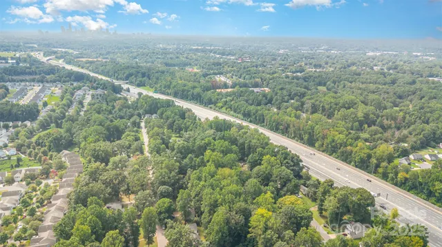 a view of a city from a balcony with a yard
