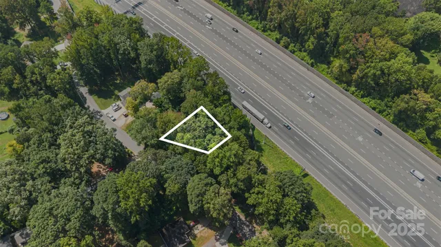 a view of a yard with potted plants
