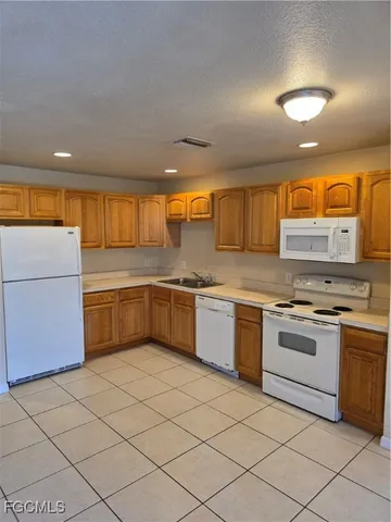 a kitchen with a sink and white cabinets