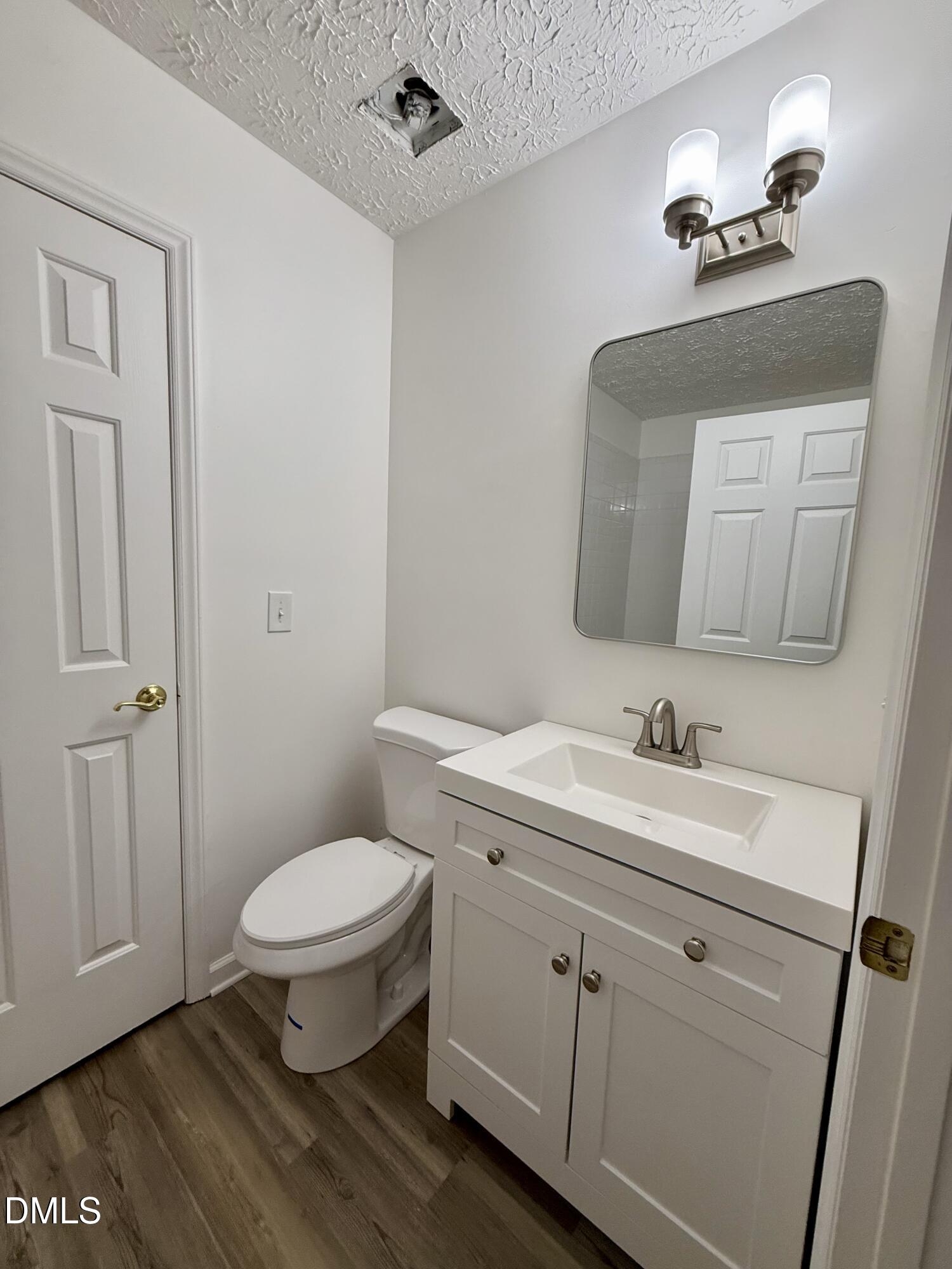 2816 Smoke Place Raleigh, NC 27610 - Photo 14 of 21 a bathroom with a toilet a sink and mirror