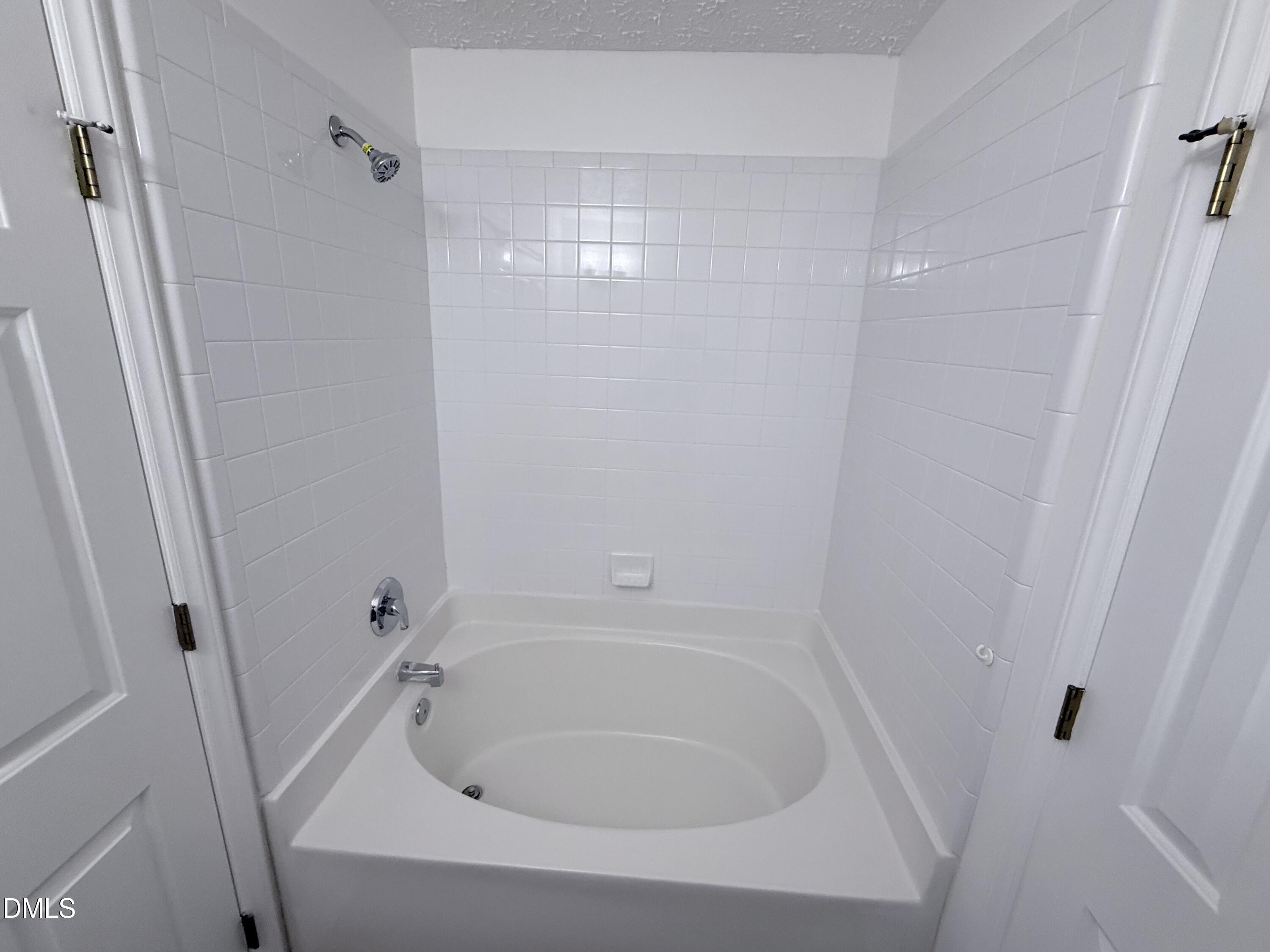 2816 Smoke Place Raleigh, NC 27610 - Photo 15 of 21 a white bath tub sitting in a bathroom