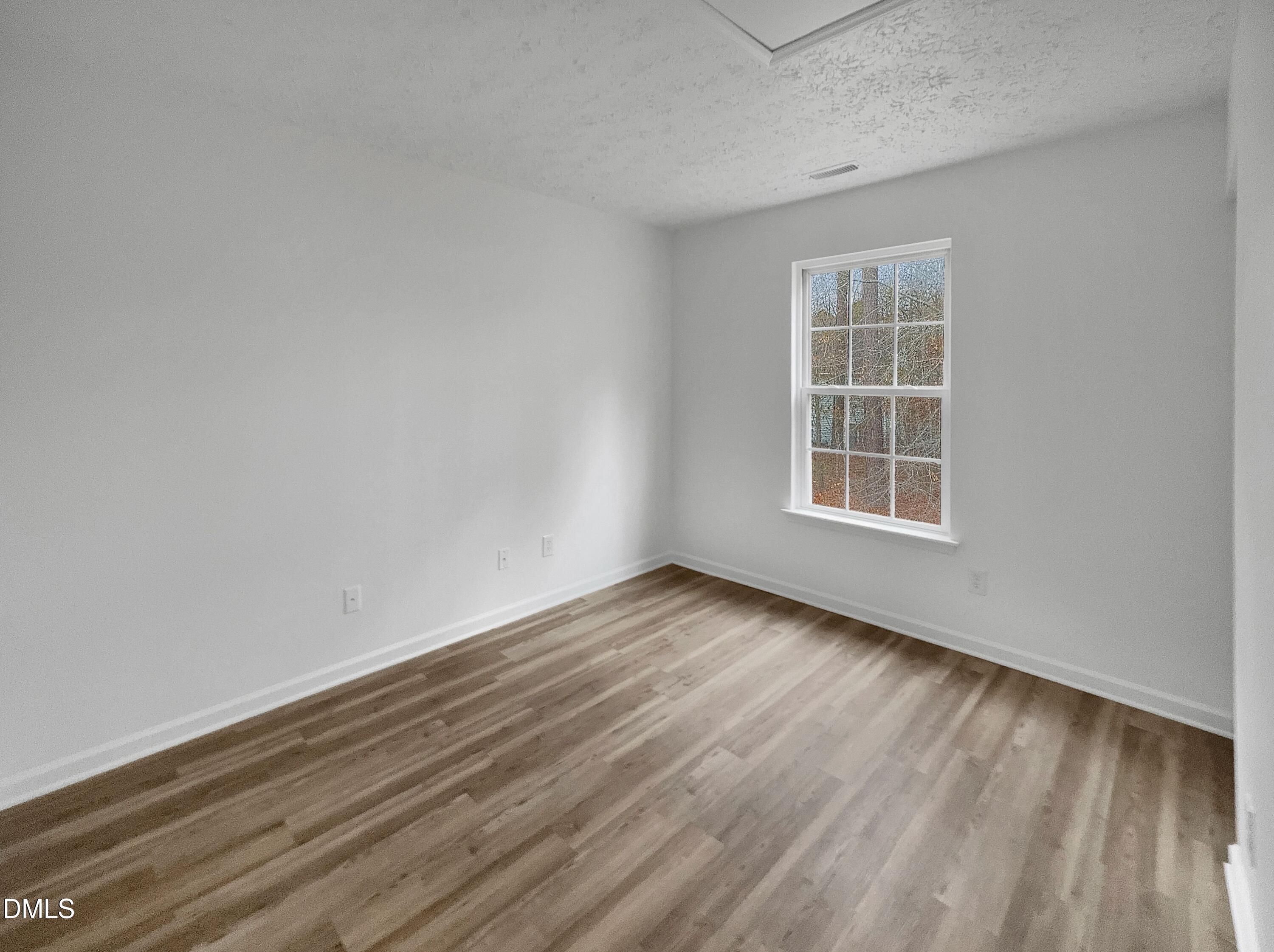 2816 Smoke Place Raleigh, NC 27610 - Photo 17 of 21 an empty room with wooden floor and windows