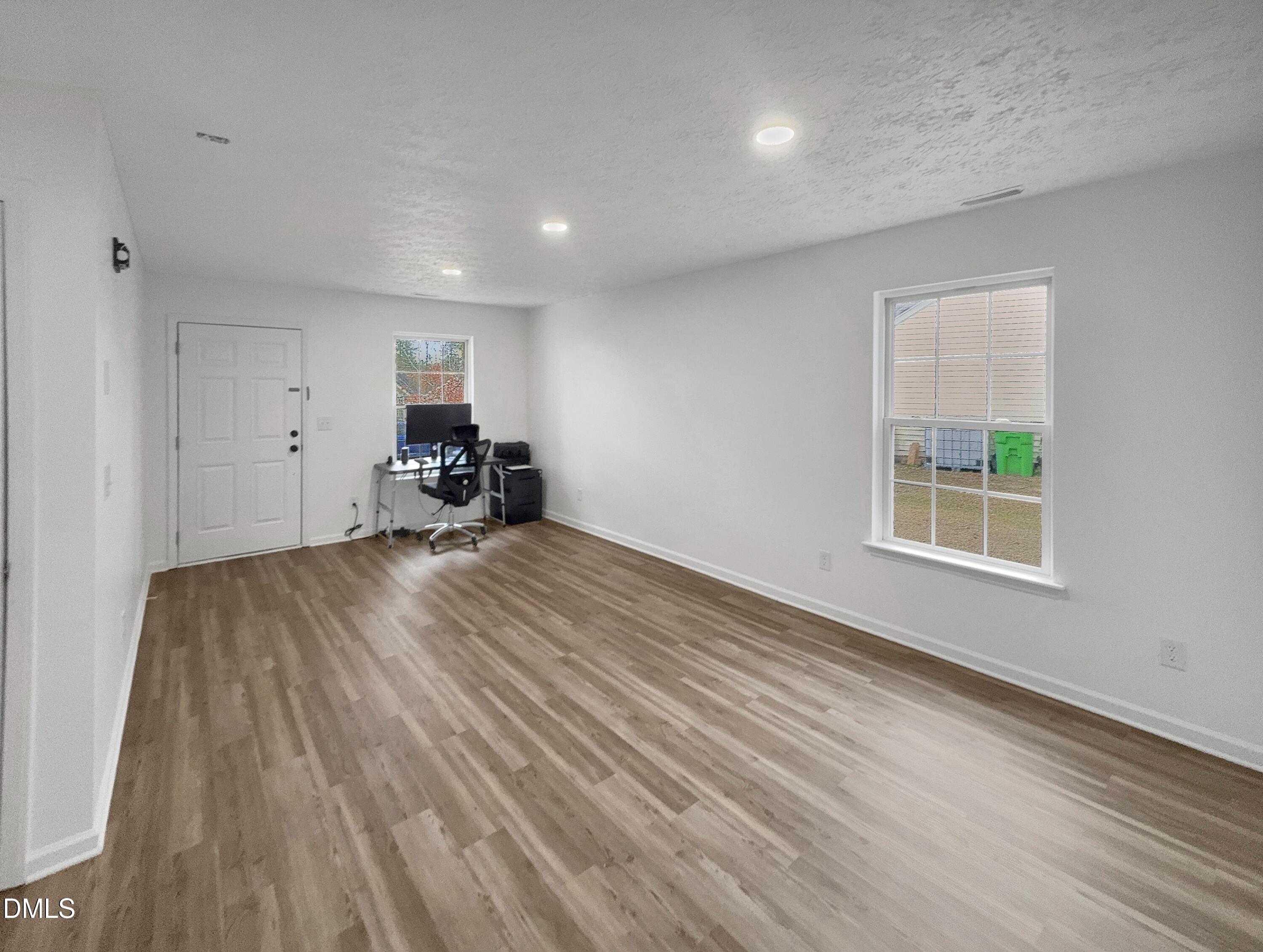 2816 Smoke Place Raleigh, NC 27610 - Photo 3 of 21 a view of empty room with wooden floor and a window