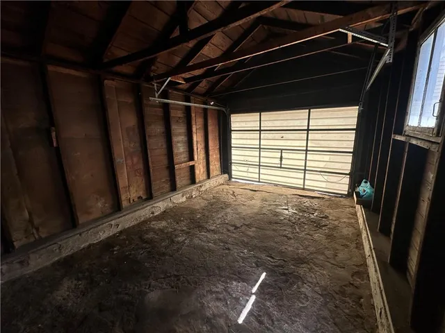 a view of empty room with wooden ceiling