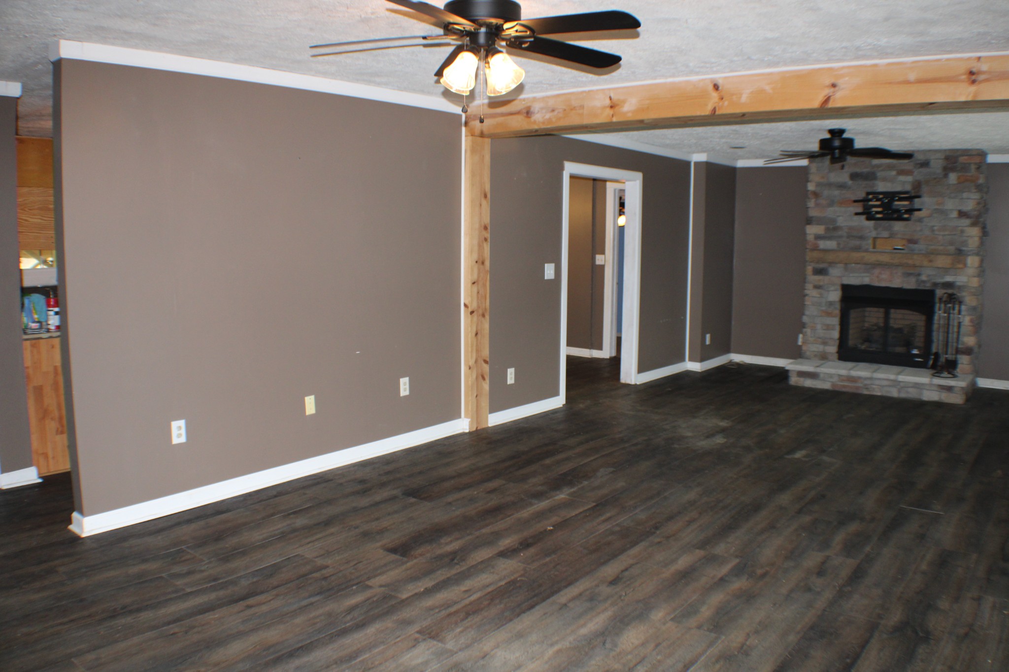 366 Pea Ridge Road Woodbury, TN 37190 - Photo 6 of 25 a view of a livingroom with a fireplace a ceiling fan and hardwood floor