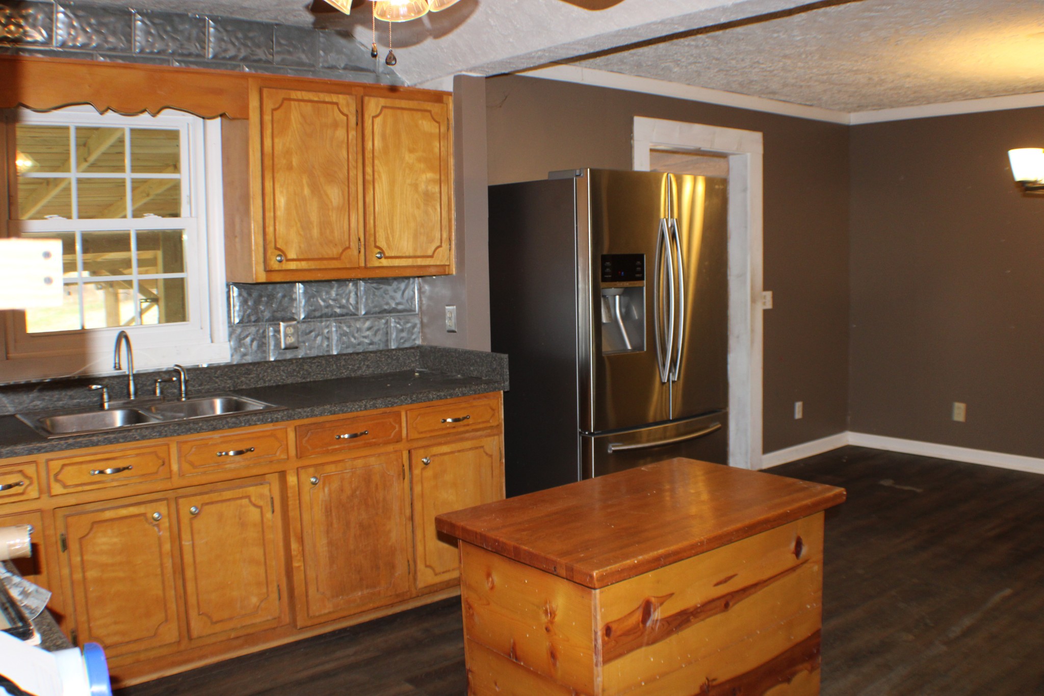 366 Pea Ridge Road Woodbury, TN 37190 - Photo 8 of 25 a kitchen with stainless steel appliances granite countertop a refrigerator a sink and dishwasher with wooden cabinets