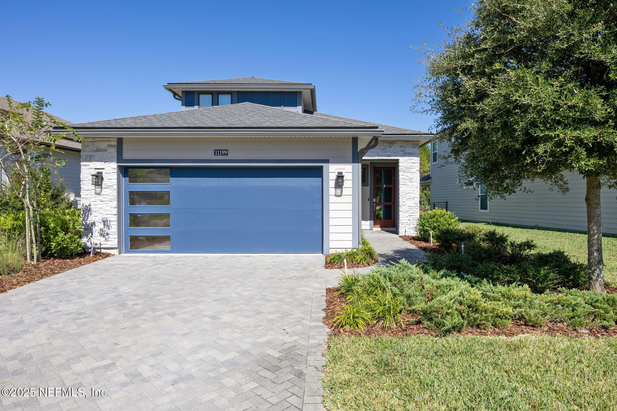 a front view of a house with a yard and garage