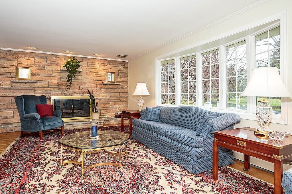 959 Brook Road Milton, MA 02186 - Photo 11 of 30 a living room with furniture and a fireplace
