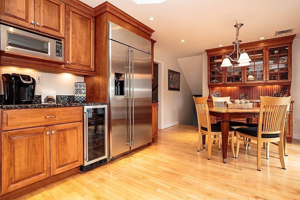 959 Brook Road Milton, MA 02186 - Photo 14 of 30 a dining area with stainless steel appliances kitchen island granite countertop a table and chairs in it
