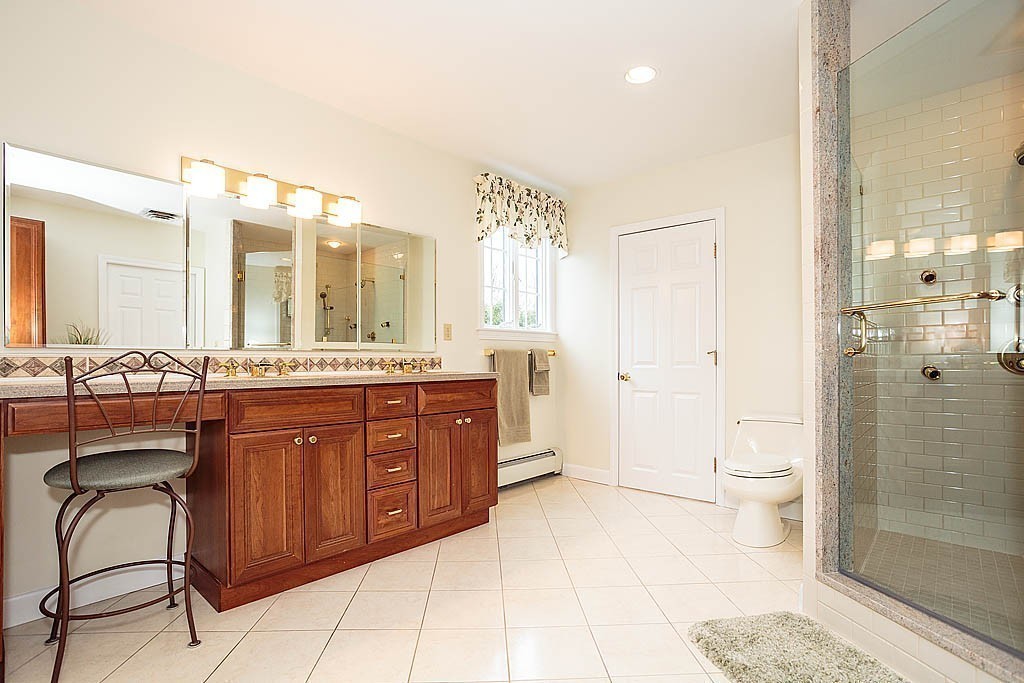 959 Brook Road Milton, MA 02186 - Photo 21 of 30 a spacious bathroom with a granite countertop sink toilet a mirror and shower