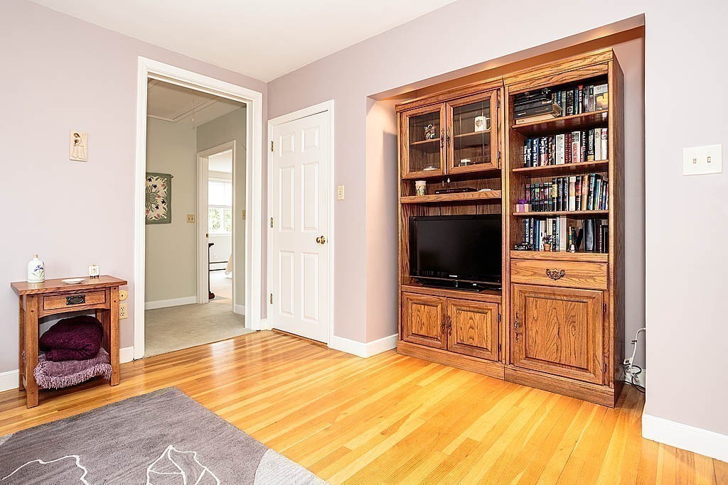 959 Brook Road Milton, MA 02186 - Photo 23 of 30 a bedroom with furniture and a fireplace