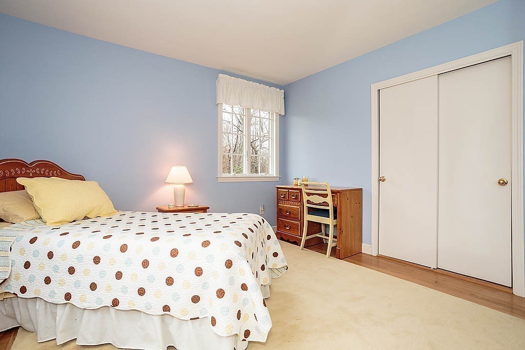 959 Brook Road Milton, MA 02186 - Photo 27 of 30 a bedroom with a bed and a closet