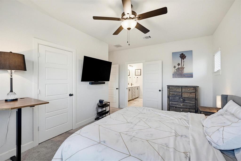 9341 Loggerhead Way Fort Worth, TX 76118 - Photo 21 of 35 Bedroom featuring light gray carpet flooring and a ceiling fan with integrated lighting
