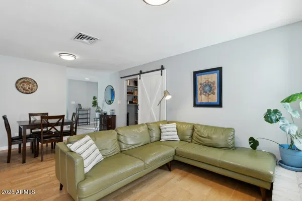 a living room with furniture and wooden floor